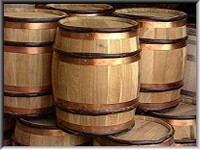 A stack of 100lb gunpowder barrels with copper and wood hoops.