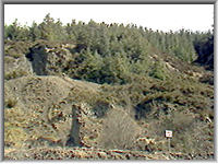 Remains of Old shaft pumping and windng engine houses on the hillside above the road in 1985.